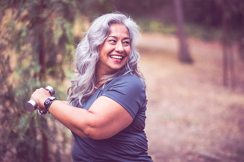 happy gray-haired lady over 40 exercising to lose menopause weight