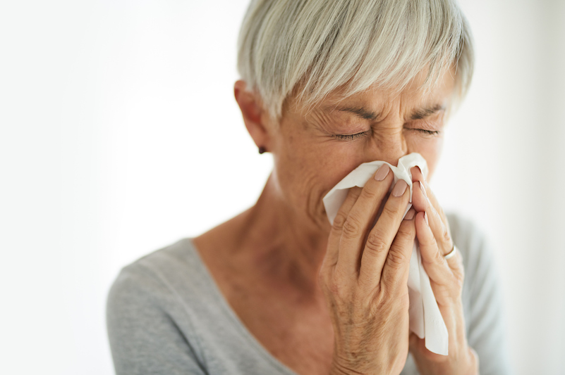 woman sneezing needs allergy meds