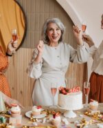 three middle aged women looking happy having drinks