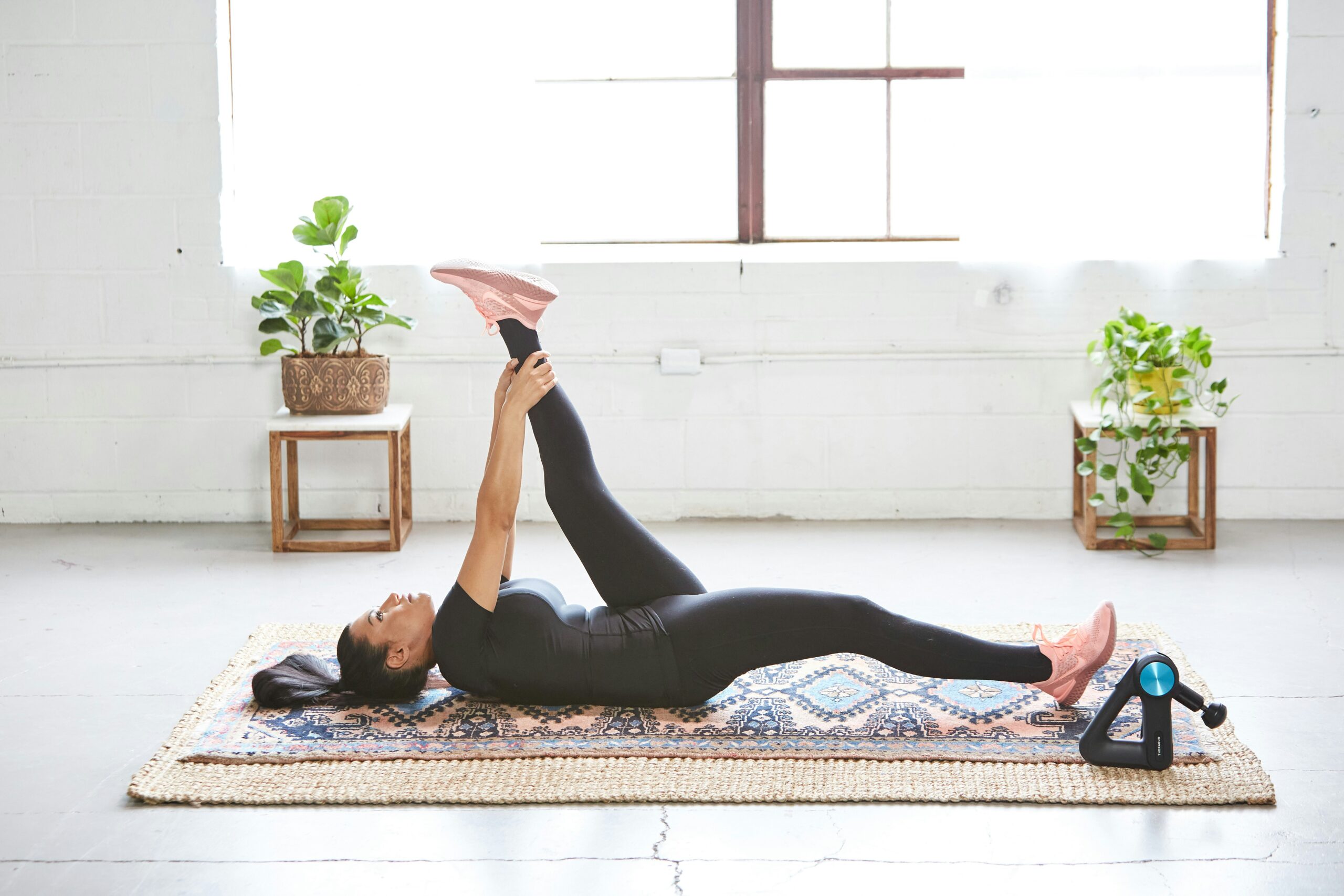 woman exercising holding one leg up