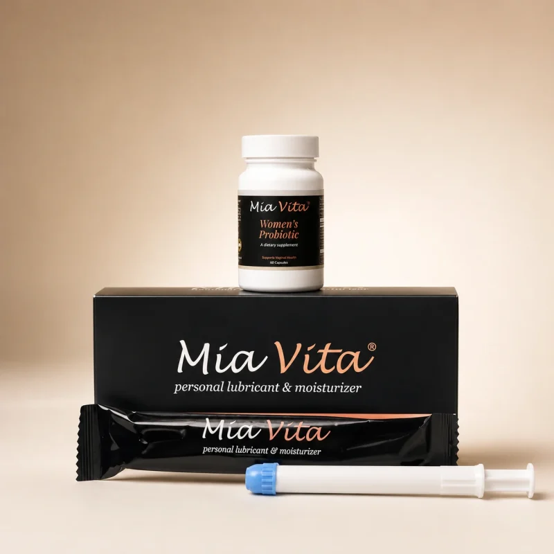 1 box of Mia Vita® Personal Lubricant & Moisturizer with 1 bottle of Mia Vita® Women’s Probiotic supplement on top. One unwrapped applicator is showing on the table.