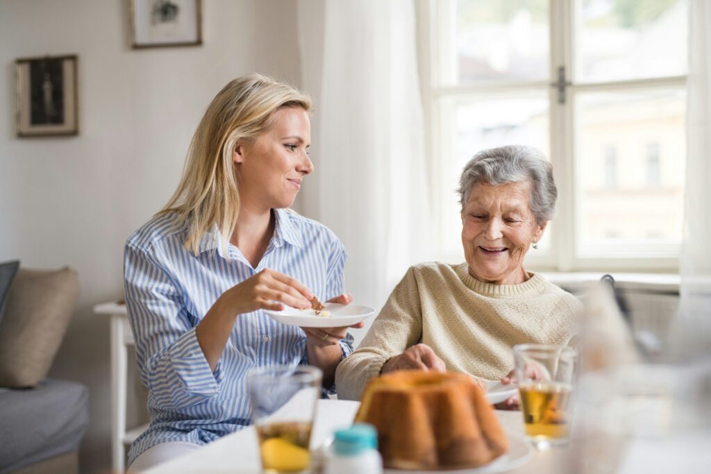 caregiver sitting with mature woman