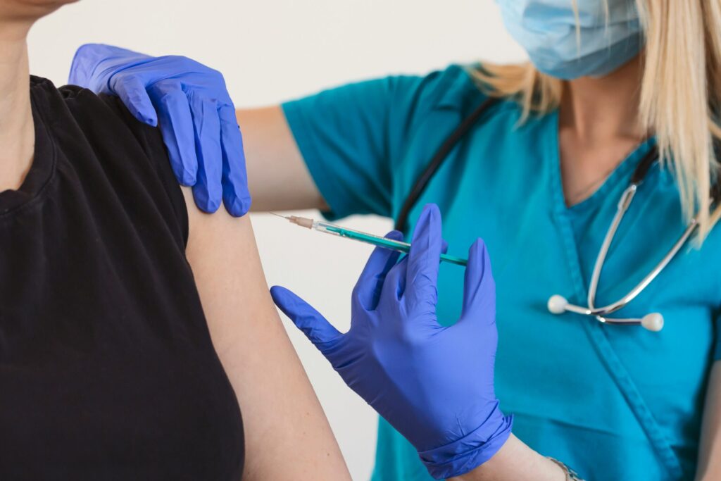nurse injecting woman