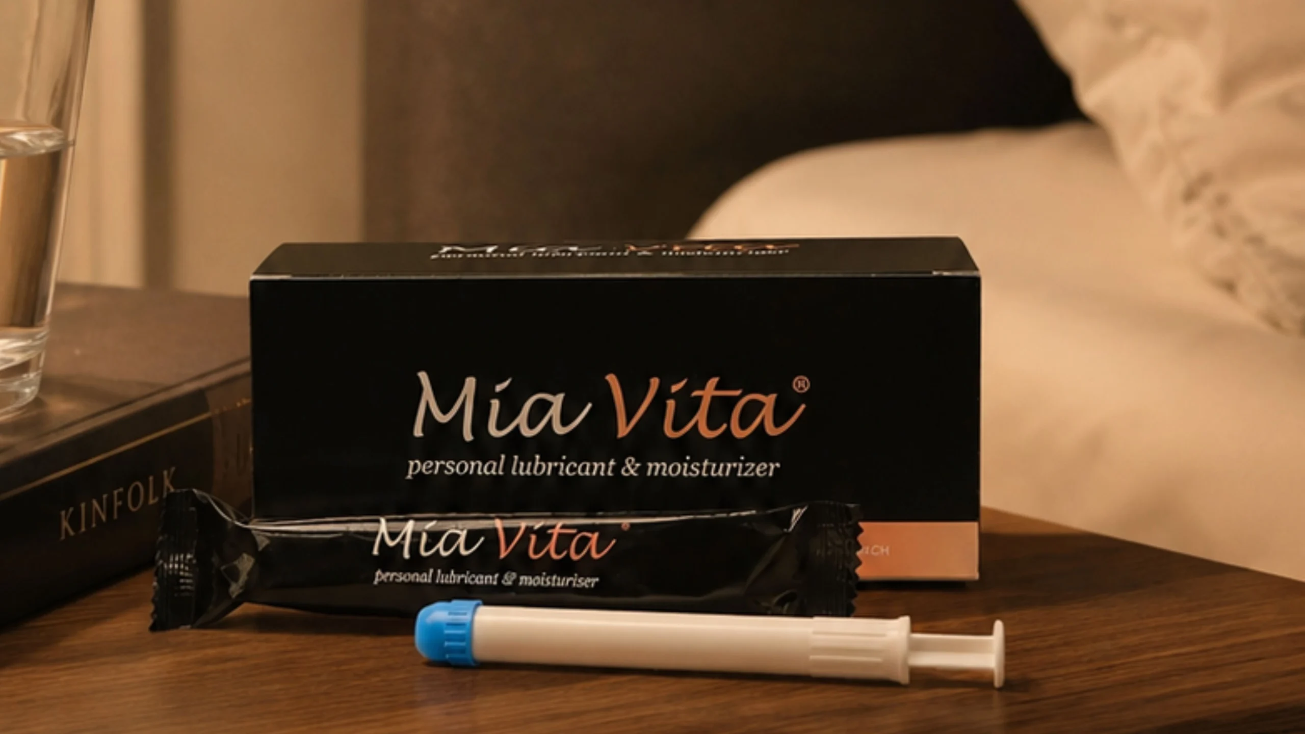 Image of Mia Vita Personal Lubricant & Moisturizer next to a bed..