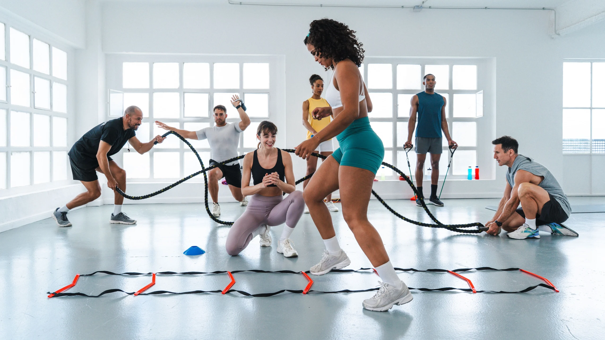 Women in neuro fitness class using tools such as agility ladder and battle ropes